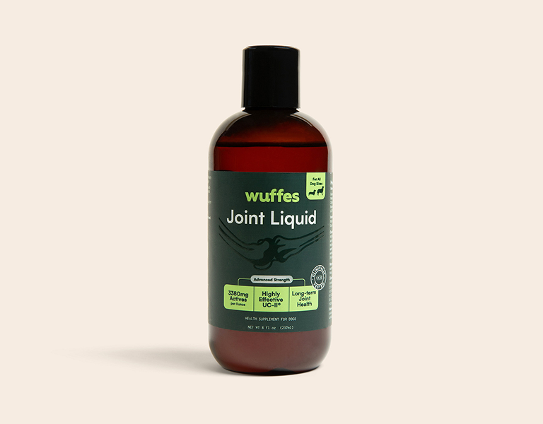 Bottle of Wuffes Joint Liquid dog supplement with green and black label and black cap
