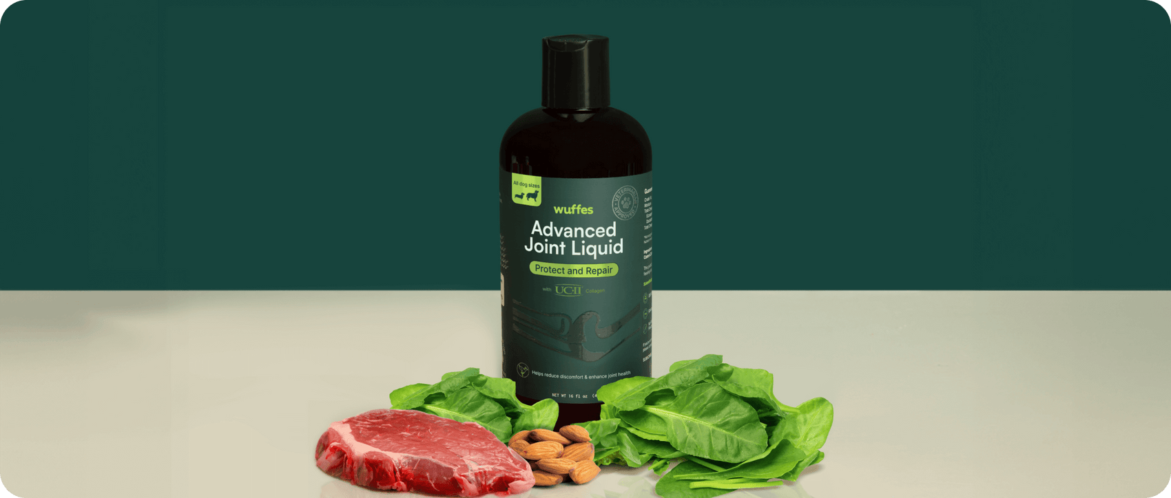 Dark bottle labeled advanced joint liquid for dogs with fresh spinach, almonds, and meat nearby