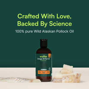Bottle of Wuffes Omega-3 fish oil with pollock pieces on white surface and green background