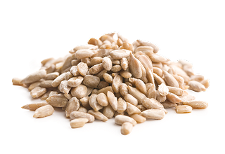 Close-up view of a small pile of shelled sunflower seeds on a white background